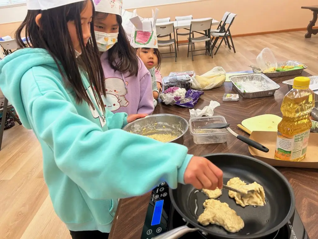 Student cooking during a Mandarin summer camp activity