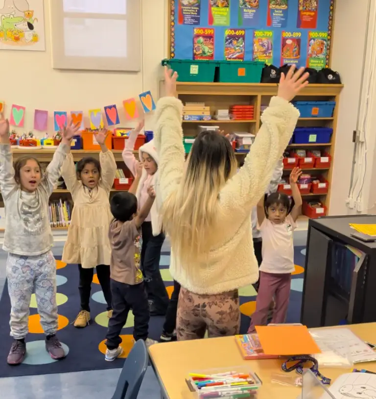 Young students raising their hands during a Mandarin class at Guadalupe Elementary in San Francisco
