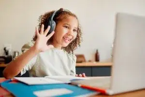 child online lesson laptop headphones
